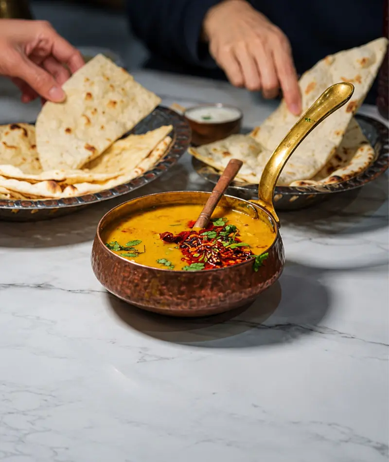 Yellow dal with tempered spices served with roti